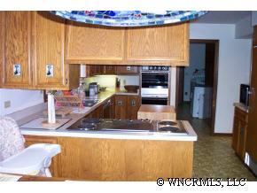 300 Upper Ridgeview Road Columbus, NC 28722 - Photo 3 of 12 a view of kitchen with stainless steel appliances granite countertop a sink and a counter