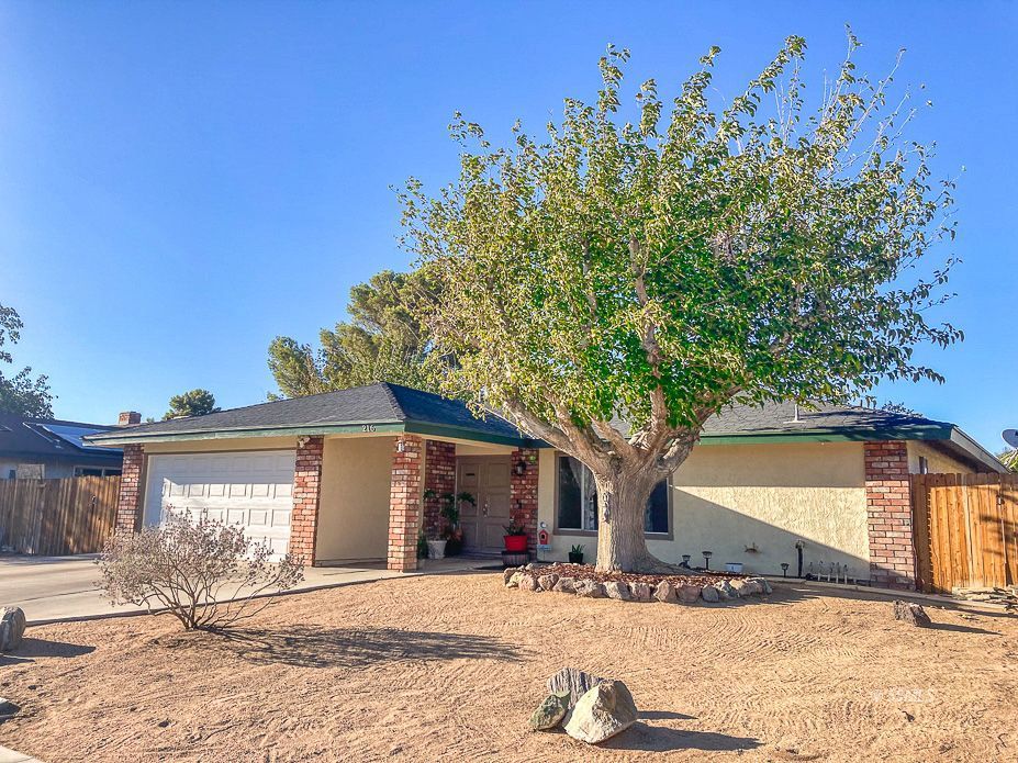 216 West Boston Avenue Ridgecrest, CA 93555 - Photo 2 of 36 a front view of a house with a yard