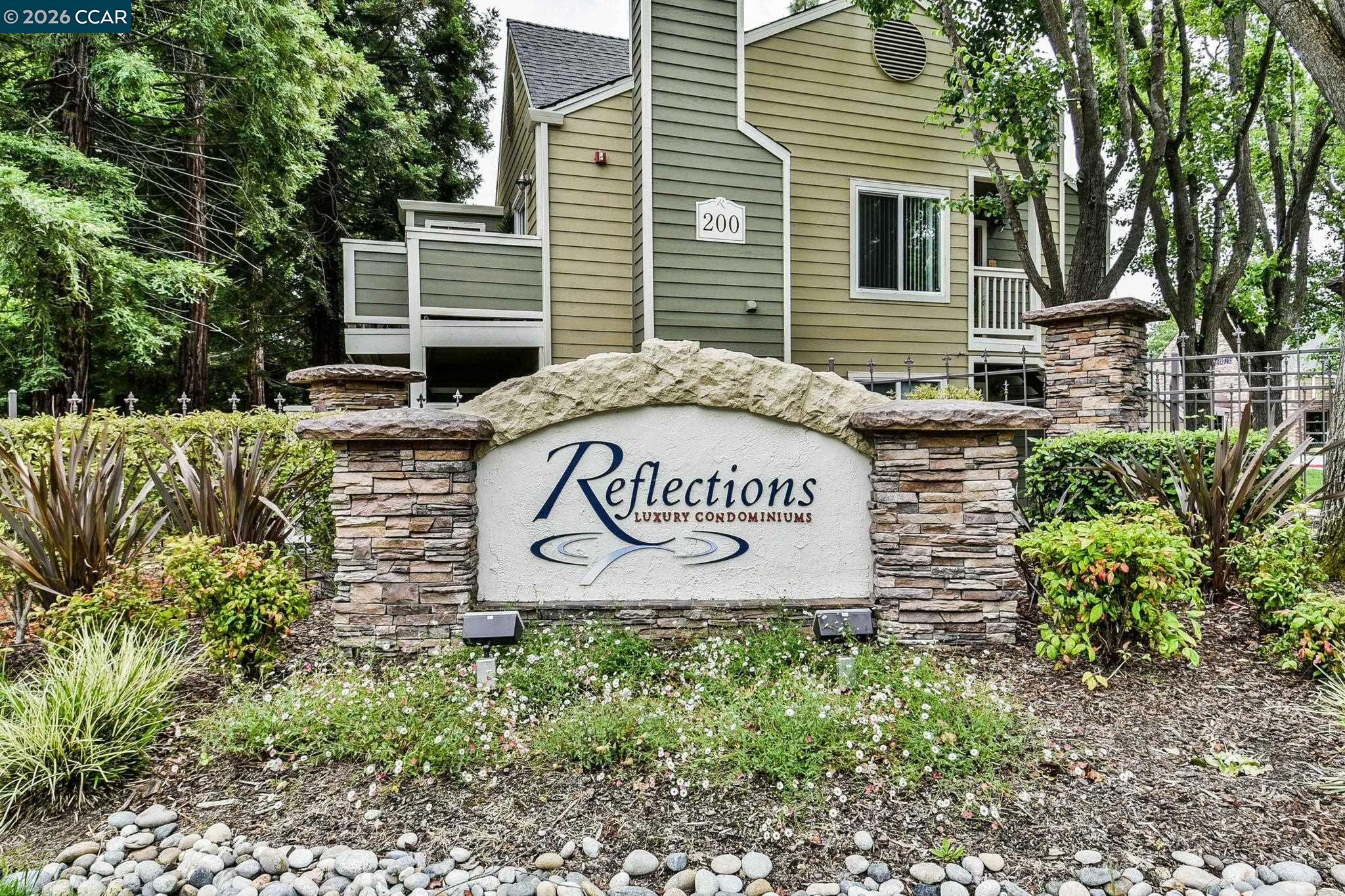 140 Reflections Drive, Unit 21 San Ramon, CA 94583 - Photo 20 of 34 a sign that is sitting on a brick wall