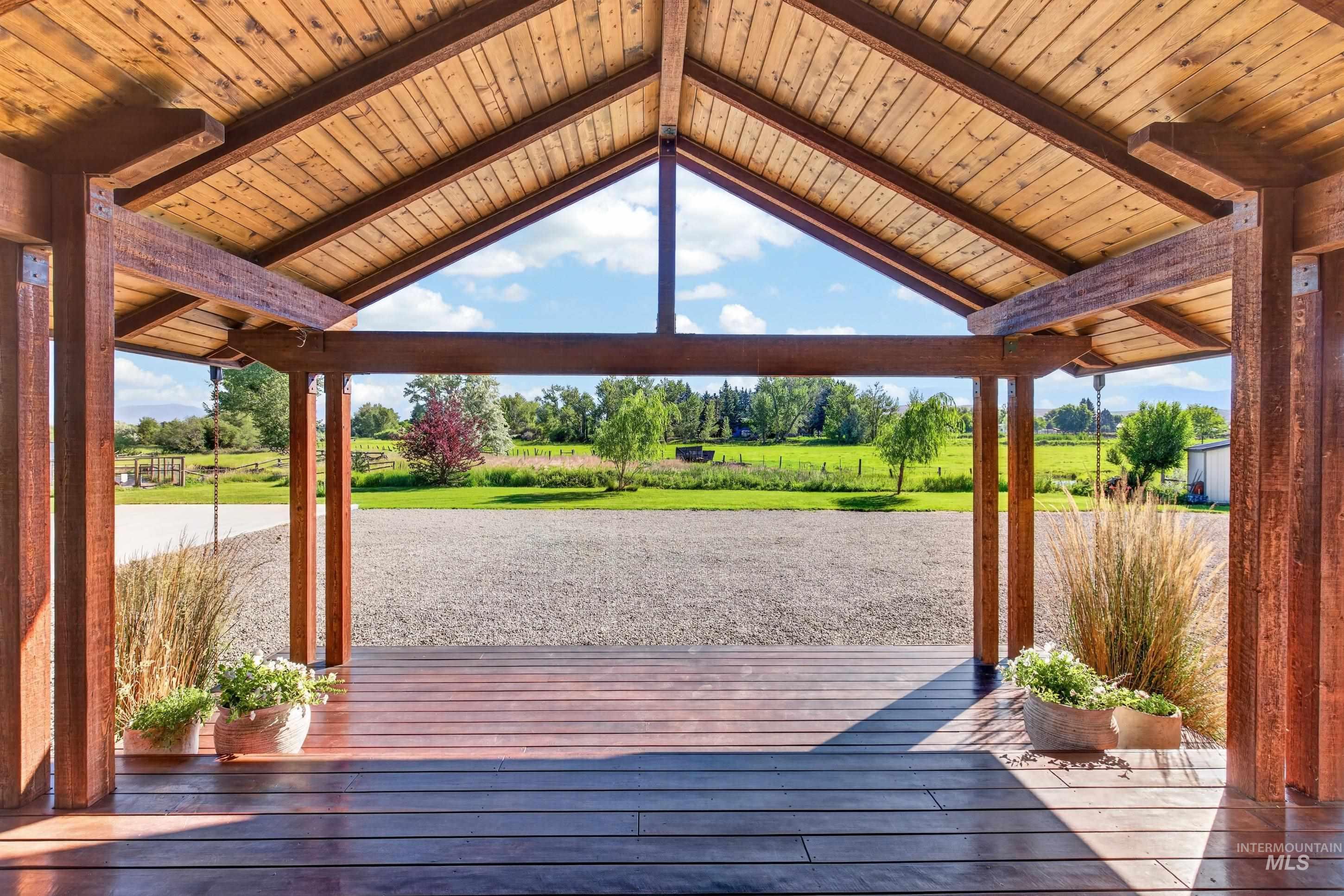 63 Mountain View Road Salmon, ID 83467 - Photo 9 of 50 Expansive covered porch featuring a vaulted wood-plank ceiling, exposed timber beams, and a wide plank wood-finish floor