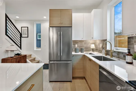 a kitchen with a refrigerator and a sink