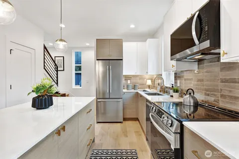 a kitchen with a sink appliances and cabinets