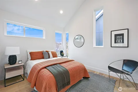 a bedroom with bed and a chair