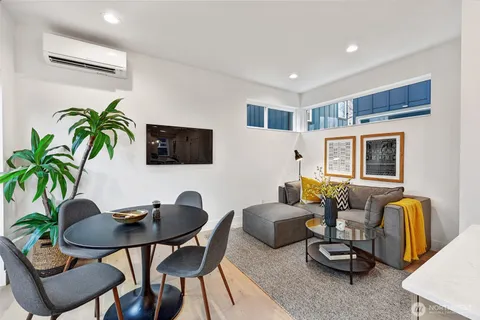 a livingroom with furniture and a potted plant