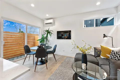 a living room with furniture wooden floor and a flat screen tv