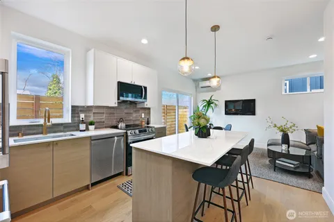 a large kitchen with a table and chairs in it