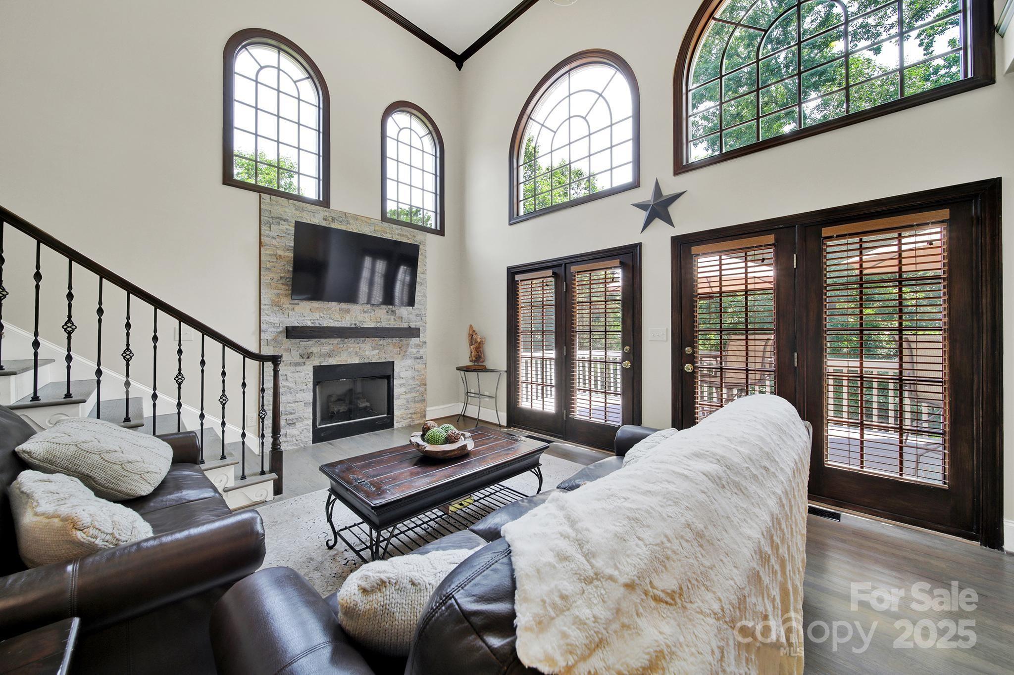 524 Wildbrook Walk Fort Mill, SC 29708 - Photo 9 of 45 a living room with furniture a fireplace and a floor to ceiling window