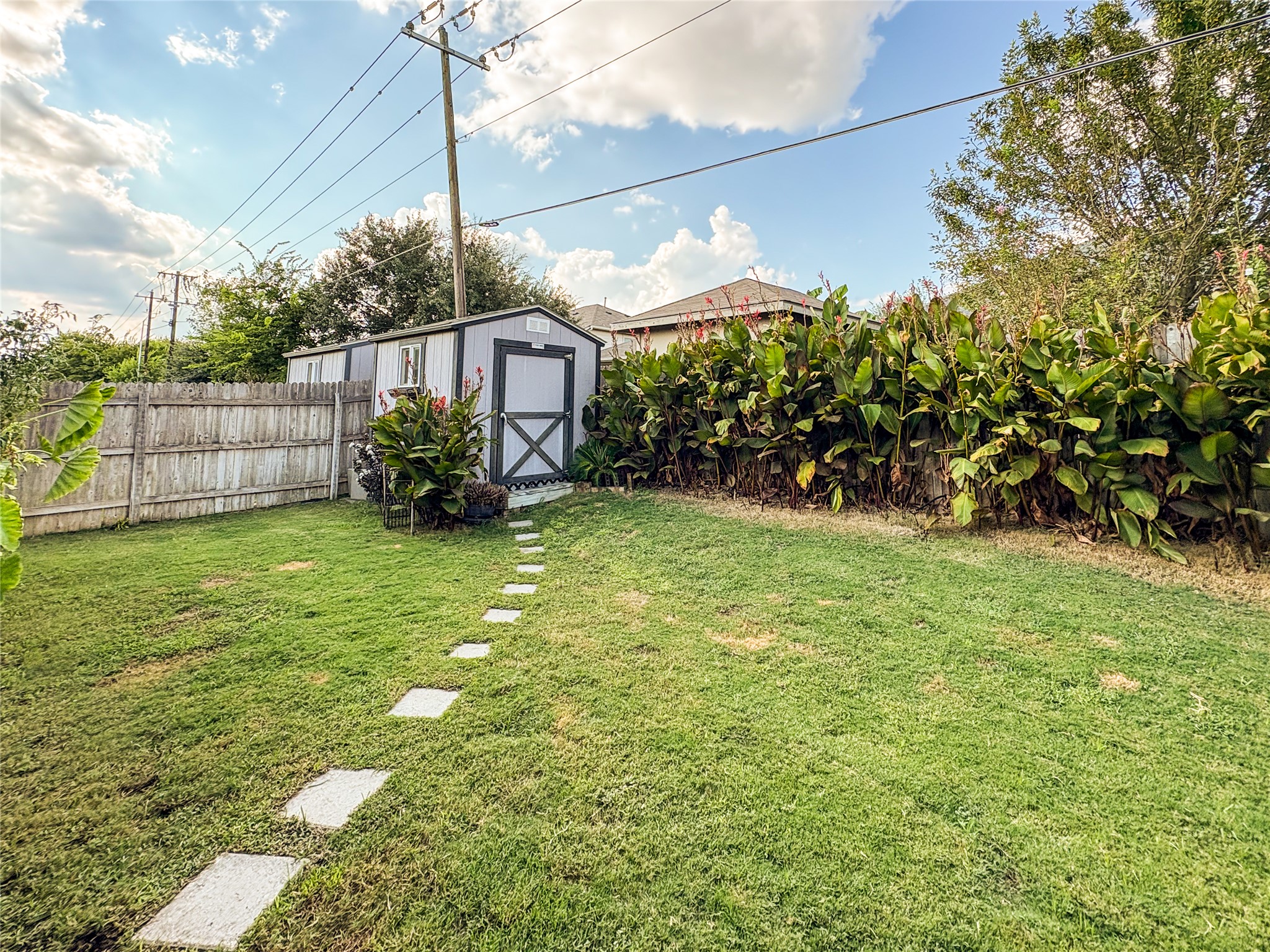 307 Andesite Trail Buda, TX 78610 - Photo 16 of 19 a view of a backyard with a garden