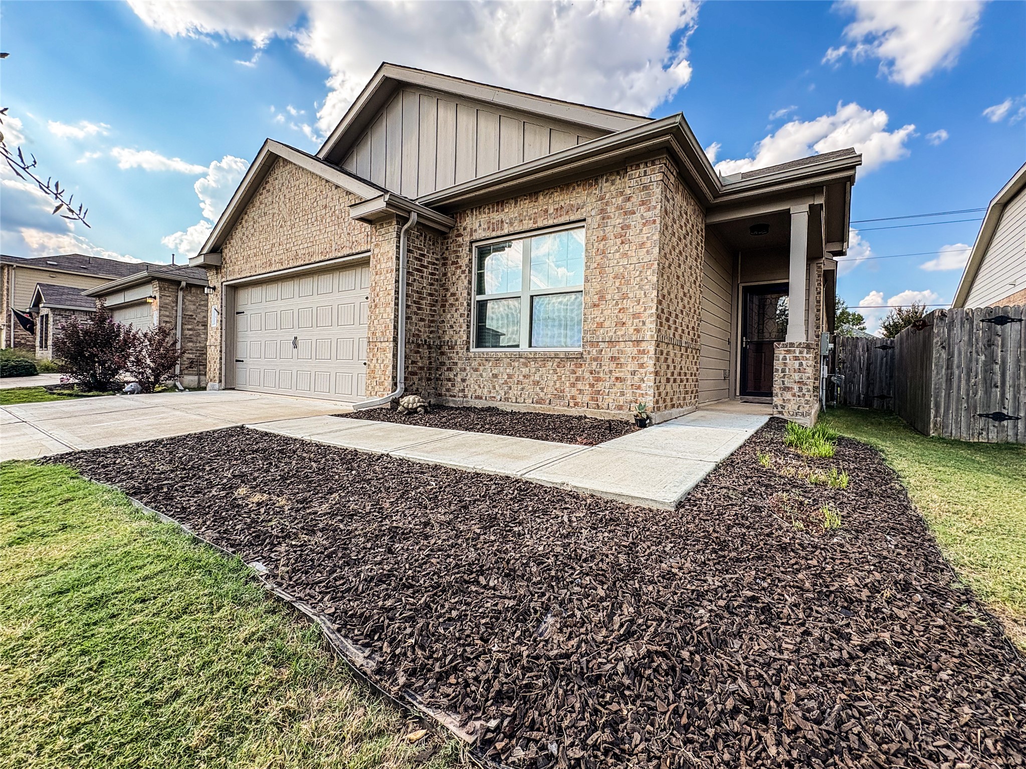 307 Andesite Trail Buda, TX 78610 - Photo 2 of 19 a front view of a house with a yard and garage