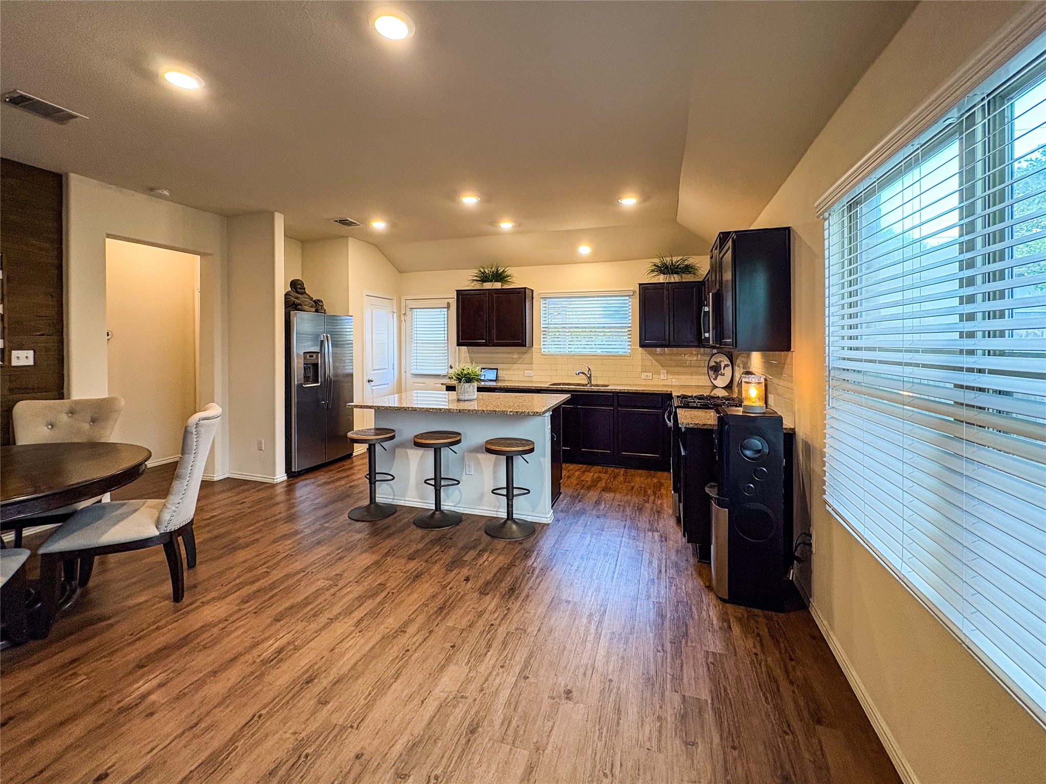 307 Andesite Trail Buda, TX 78610 - Photo 5 of 19 a living room with stainless steel appliances furniture wooden floor and a kitchen view