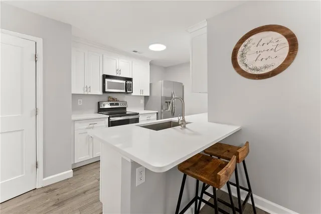 a kitchen with a table and a refrigerator