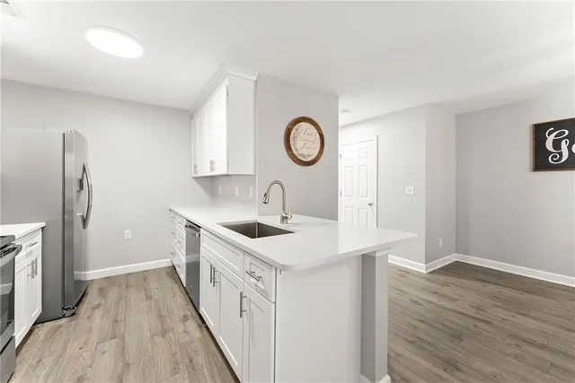 a kitchen with a sink and a refrigerator