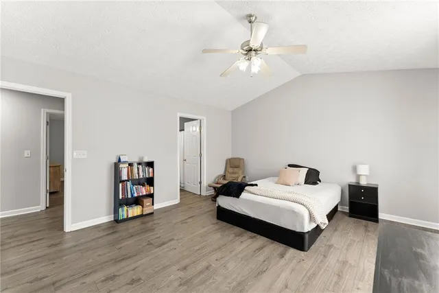 a spacious bedroom with a bed and a chandelier