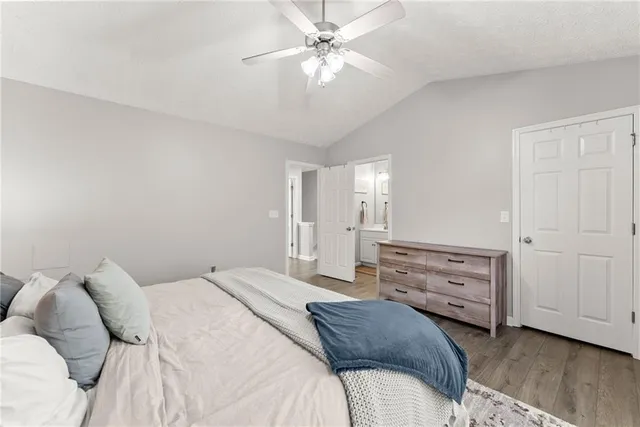 a bedroom with a bed and a ceiling fan