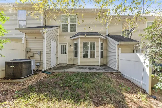 a view of a brick house with many windows