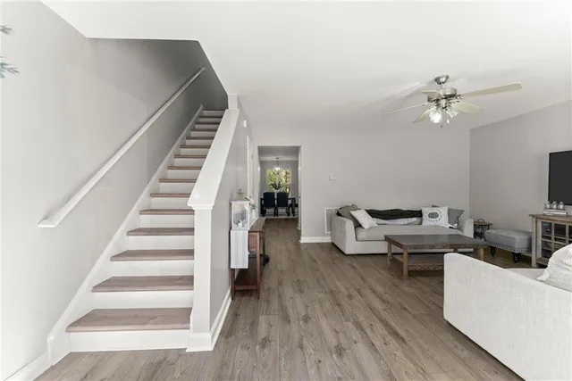 a living room with furniture and a wooden floor