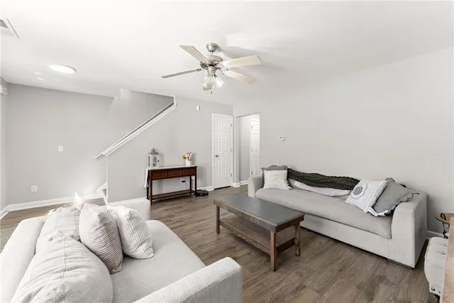 a living room with furniture and wooden floor