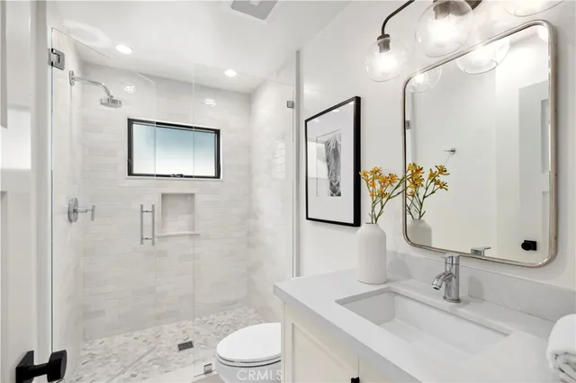 a bathroom with a toilet sink and shower