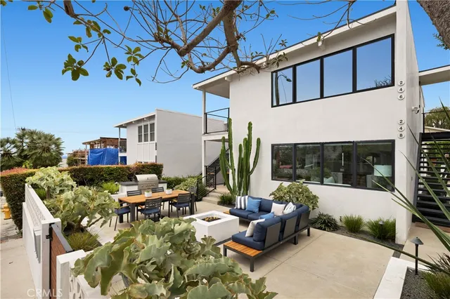 a view of backyard of house with seating space