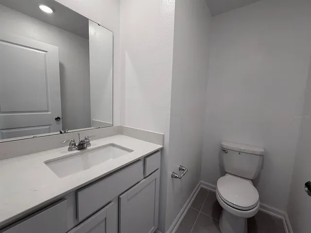 a bathroom with a sink toilet and a mirror