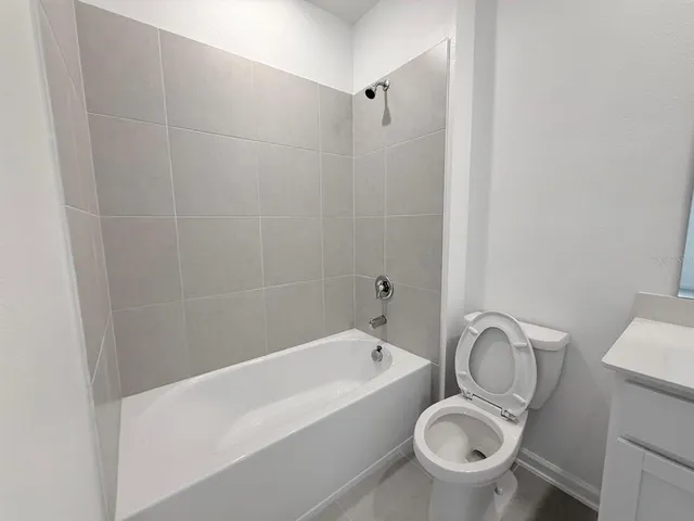 a bathroom with a sink a toilet and bathtub