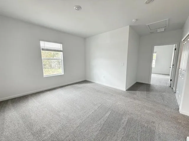 an empty room with a window and a fireplace