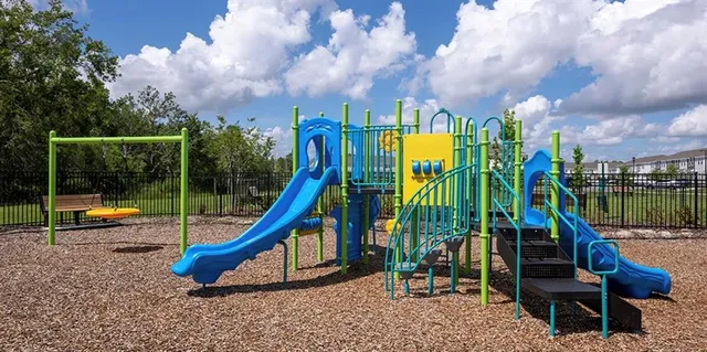 a view of a park with slide and a slide