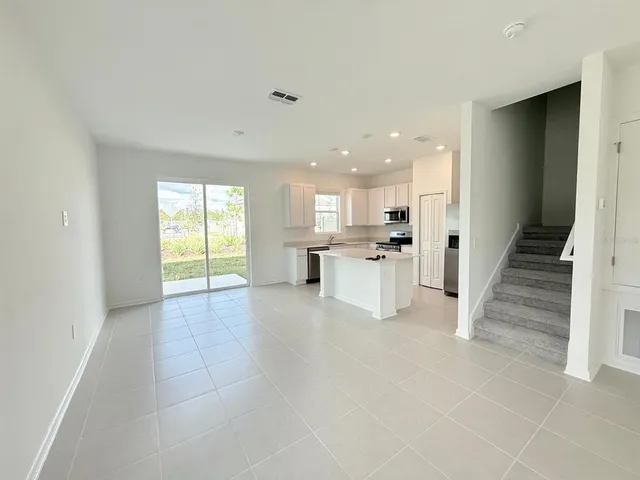 a view of kitchen with wooden floor and electronic appliances