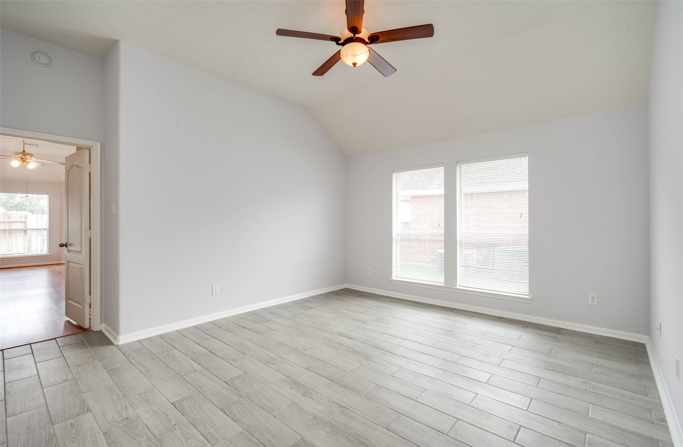 9323 Hillhaven Court Rosenberg, TX 77469 - Photo 30 of 37 an empty room with wooden floor fan and windows