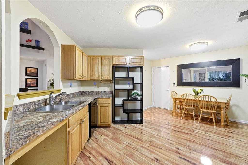 20 Ivans Circle Covington, GA 30016 - Photo 12 of 29 a kitchen with stainless steel appliances granite countertop a sink and cabinets