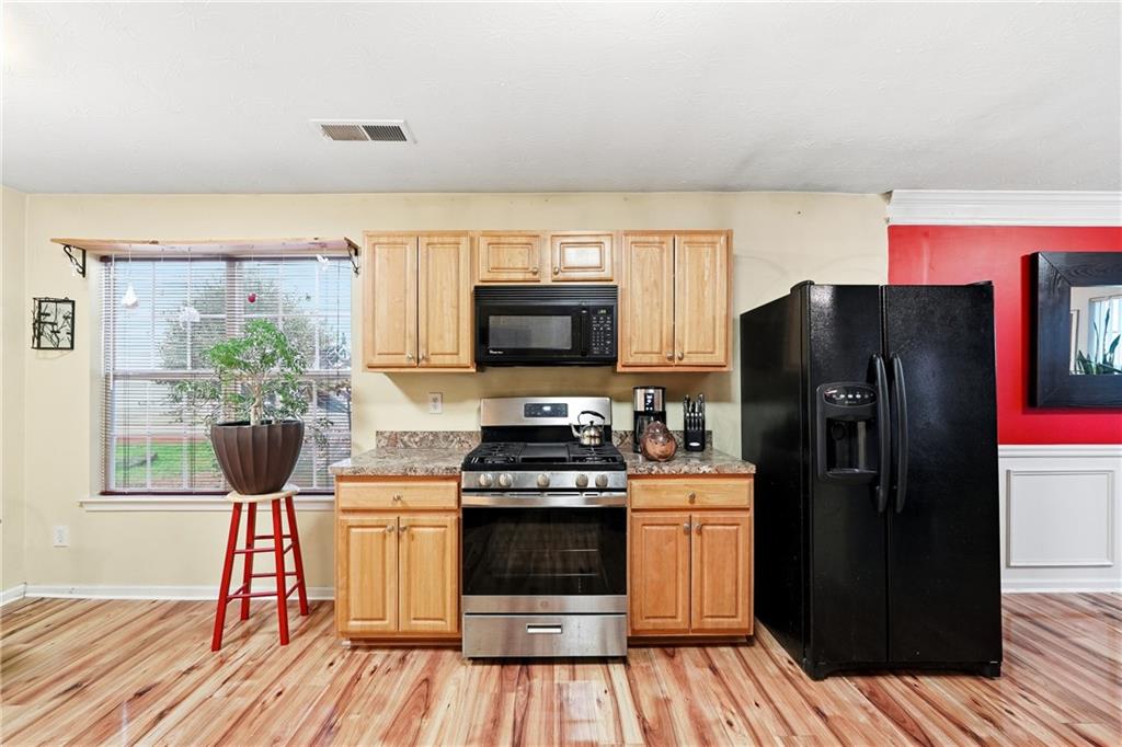 20 Ivans Circle Covington, GA 30016 - Photo 14 of 29 a kitchen with stainless steel appliances a refrigerator stove and microwave