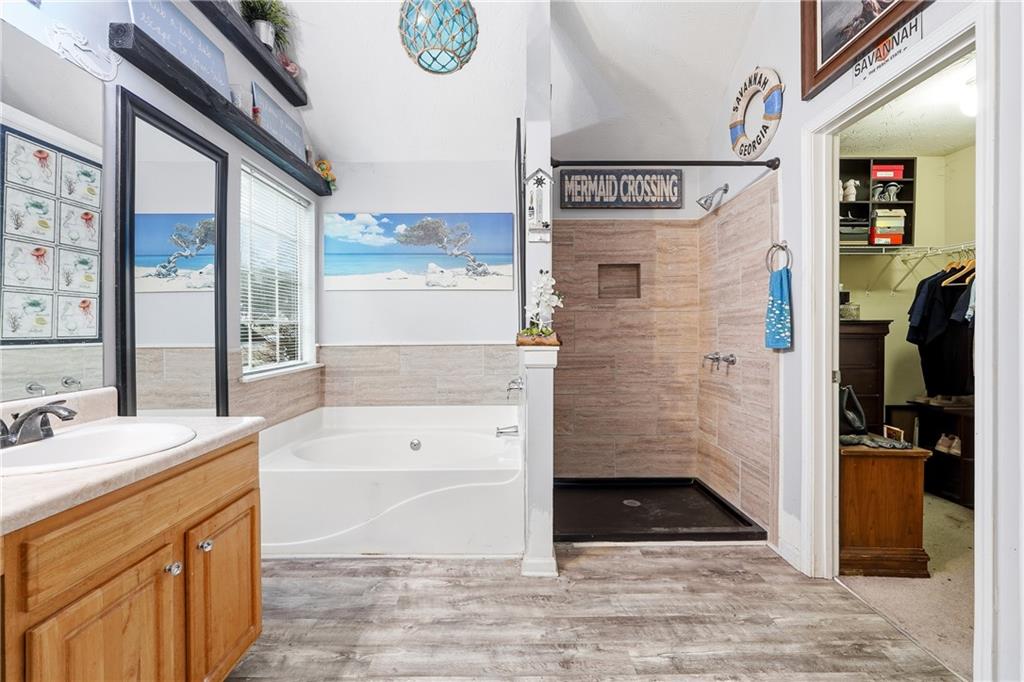 20 Ivans Circle Covington, GA 30016 - Photo 21 of 29 a bathroom with a bathtub and a shower