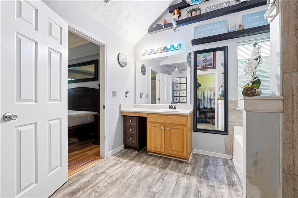 20 Ivans Circle Covington, GA 30016 - Photo 22 of 29 a spacious bathroom with a granite countertop sink and a mirror