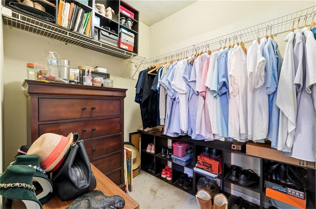 20 Ivans Circle Covington, GA 30016 - Photo 23 of 29 a view of walk in closet with clothes and shoes