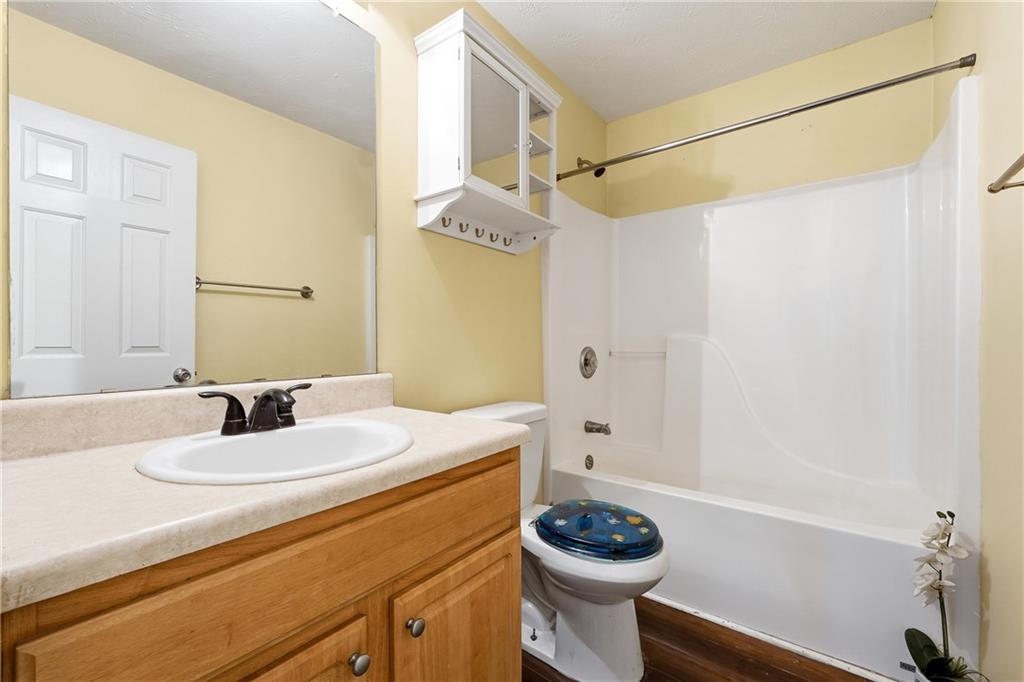 20 Ivans Circle Covington, GA 30016 - Photo 25 of 29 a bathroom with a sink a toilet and shower