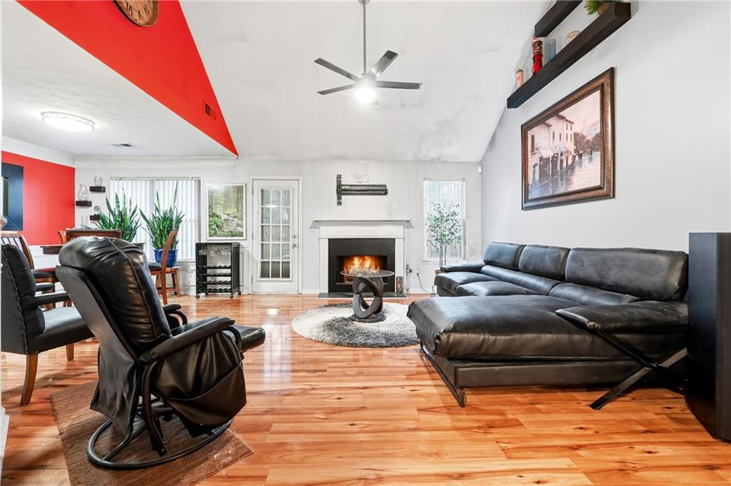 20 Ivans Circle Covington, GA 30016 - Photo 7 of 29 a living room with furniture a fireplace and a flat screen tv