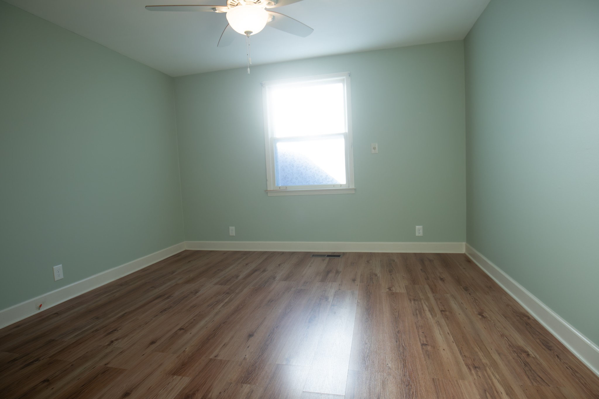 709 Nix Pass Madison, TN 37115 - Photo 19 of 33 an empty room with wooden floor and windows