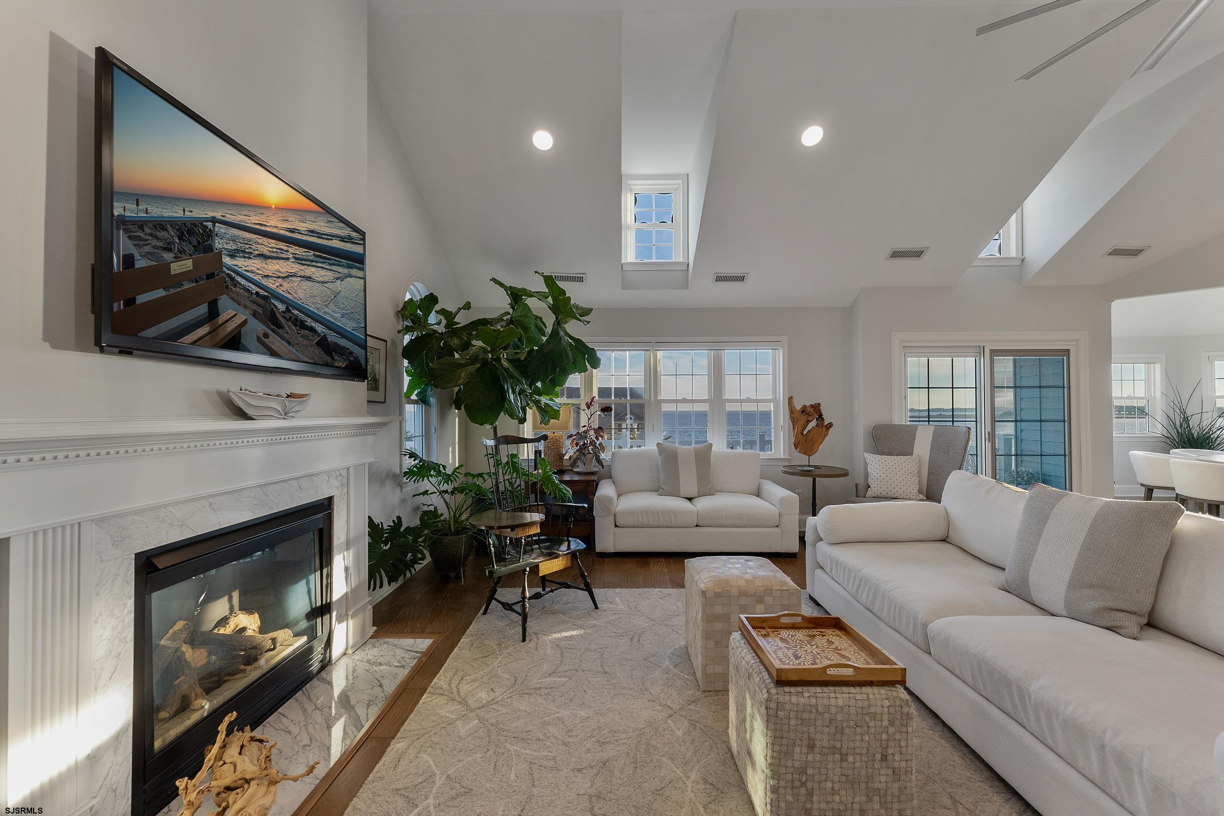 102 Broadway, Unit 2 Somers Point, NJ 08244 - Photo 15 of 98 a living room with furniture a fireplace and a flat screen tv