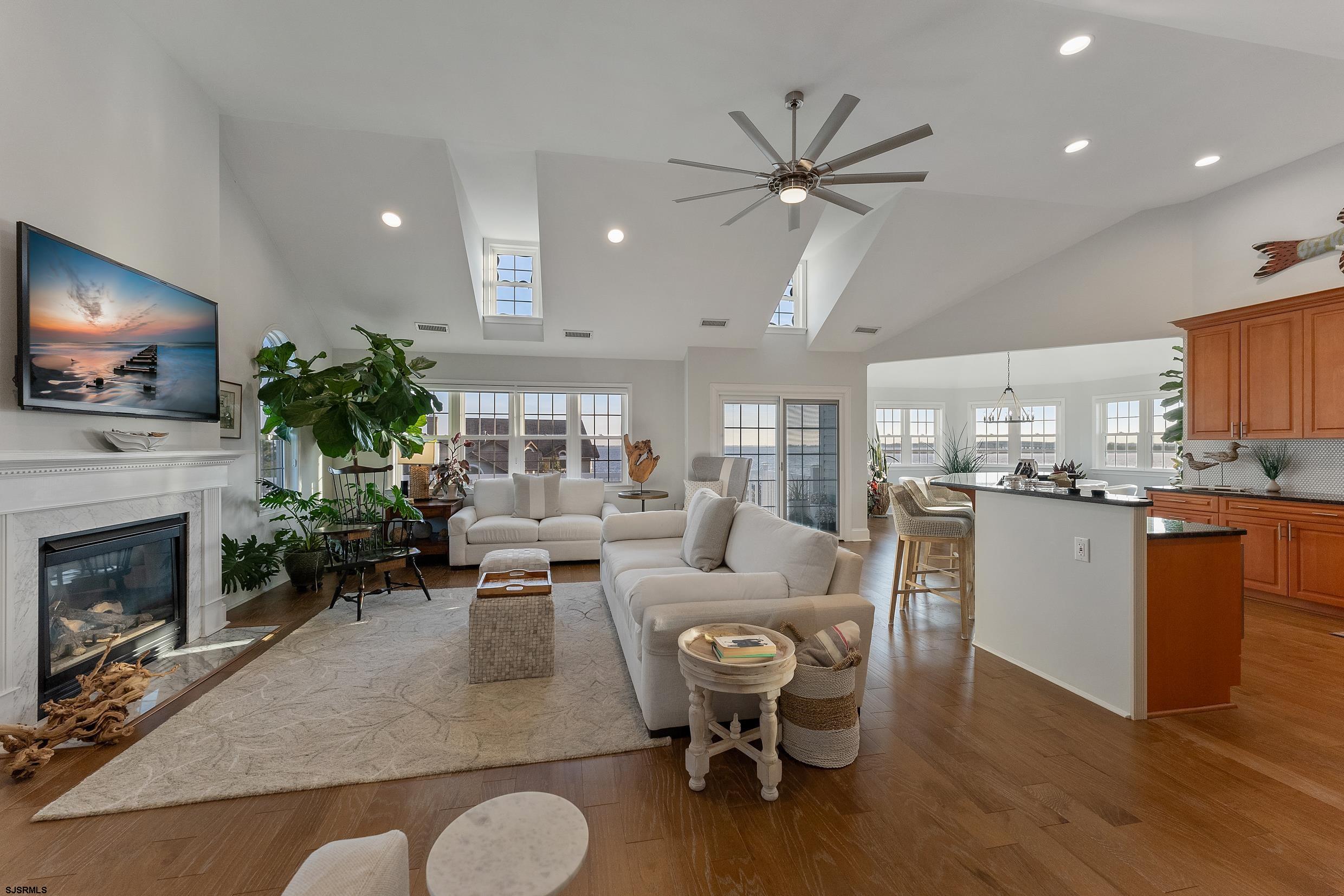 102 Broadway, Unit 2 Somers Point, NJ 08244 - Photo 16 of 98 a living room with furniture a fireplace and a flat screen tv