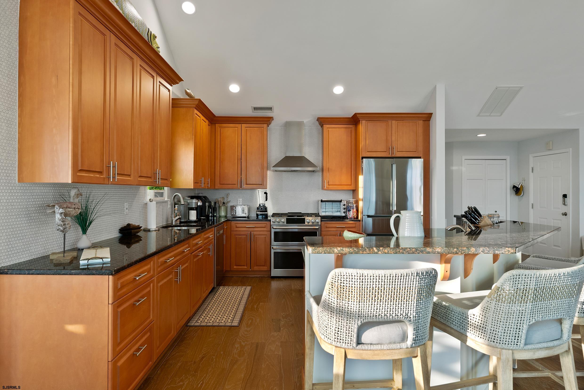 102 Broadway, Unit 2 Somers Point, NJ 08244 - Photo 21 of 98 a kitchen with stainless steel appliances granite countertop wooden cabinets a sink and a stove