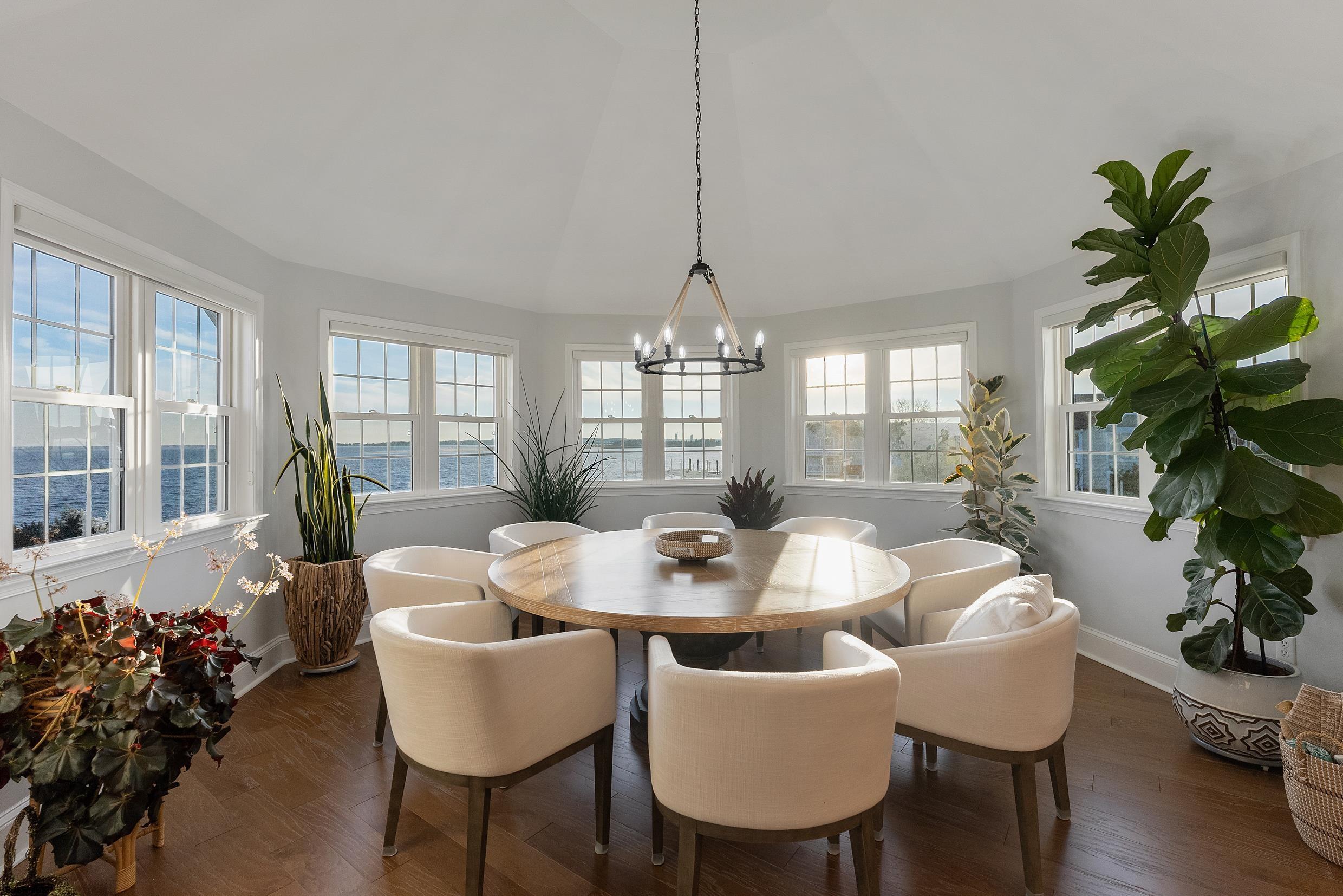 102 Broadway, Unit 2 Somers Point, NJ 08244 - Photo 30 of 98 a dining room with furniture potted plants and wooden floor