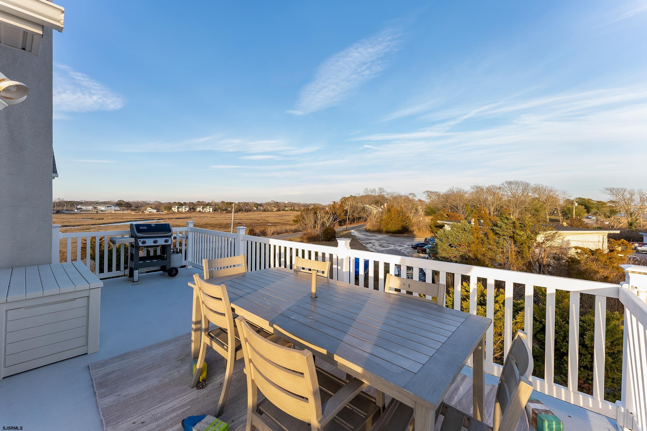 102 Broadway, Unit 2 Somers Point, NJ 08244 - Photo 31 of 98 a view of a chairs and table on the terrace