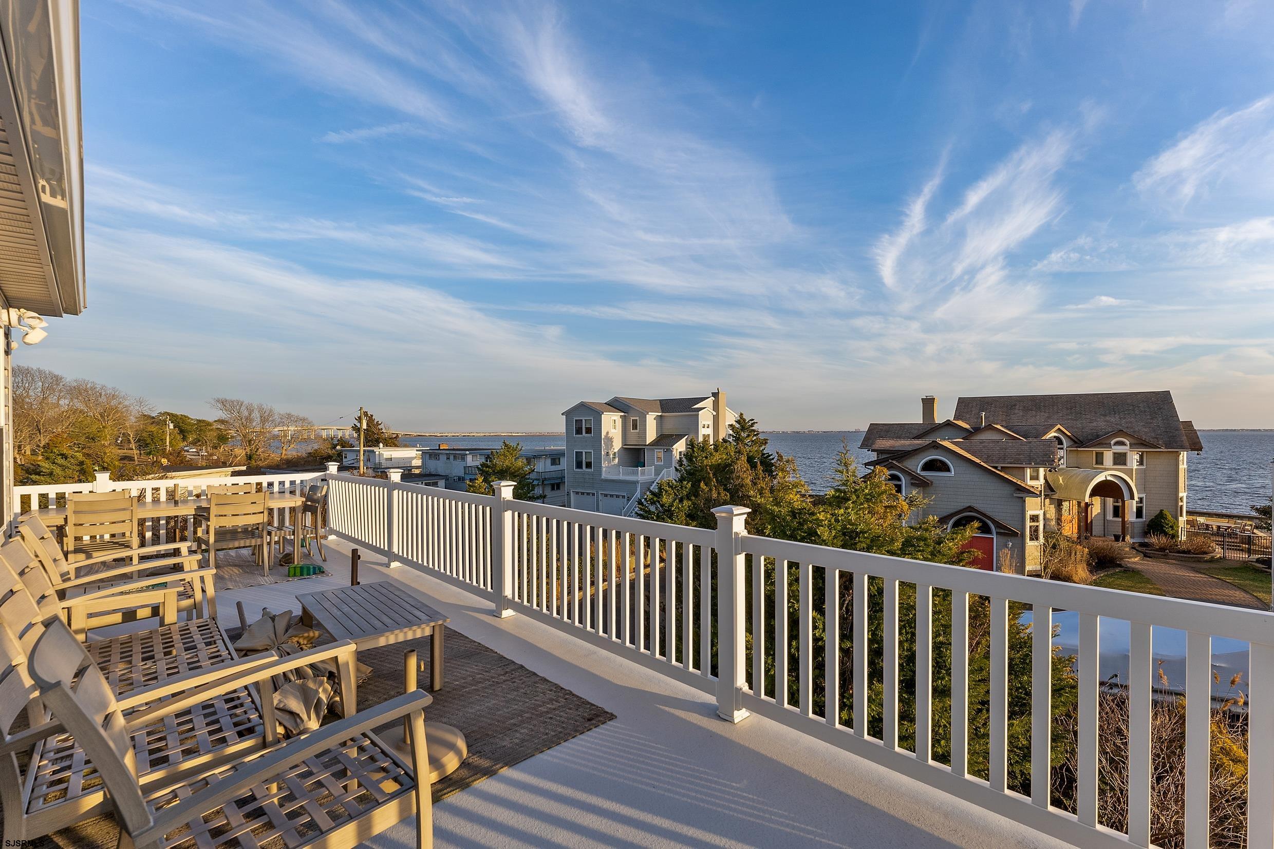 102 Broadway, Unit 2 Somers Point, NJ 08244 - Photo 35 of 98 a view of a balcony with wooden chairs