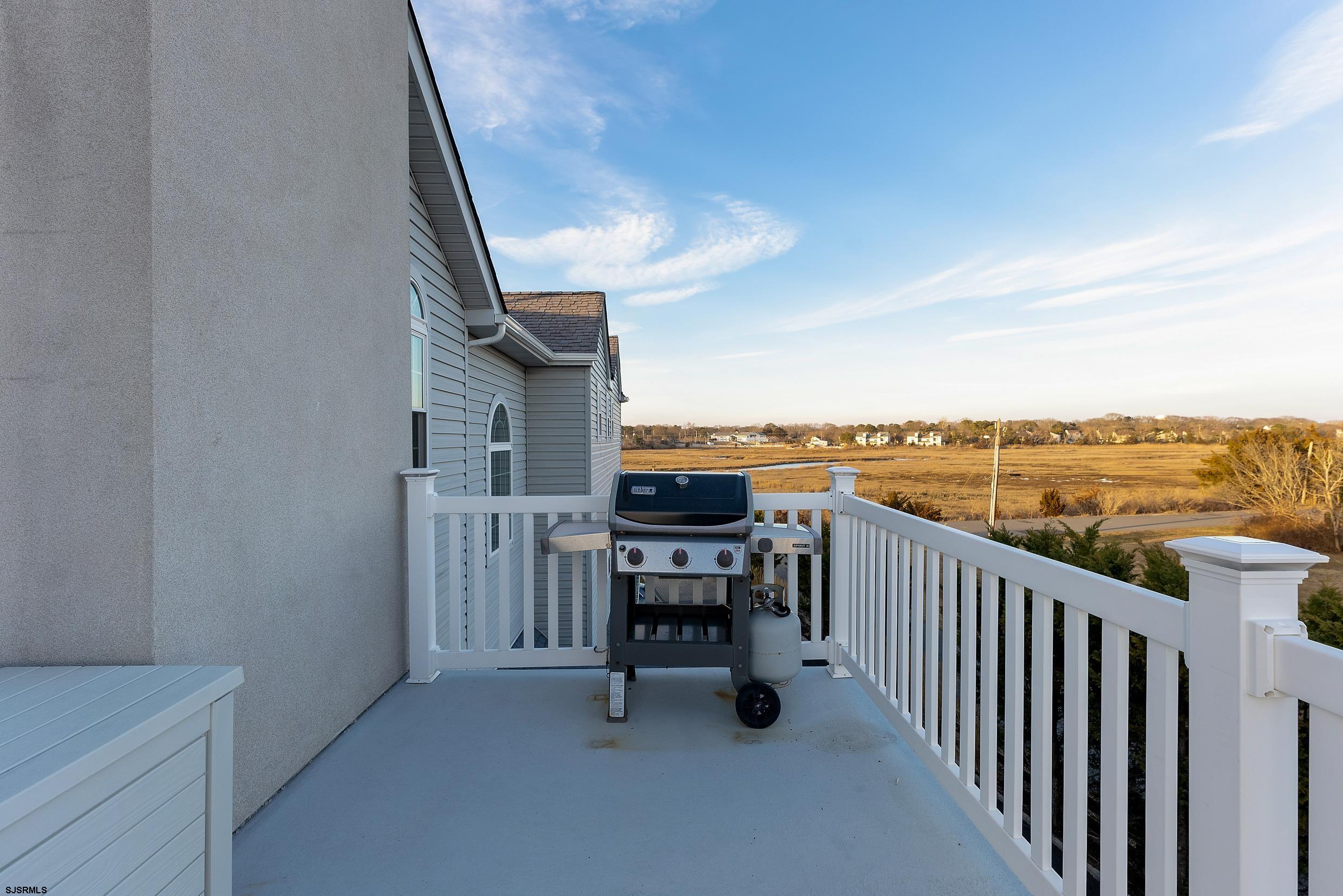 102 Broadway, Unit 2 Somers Point, NJ 08244 - Photo 37 of 98 a view of a balcony with chairs and iron fence