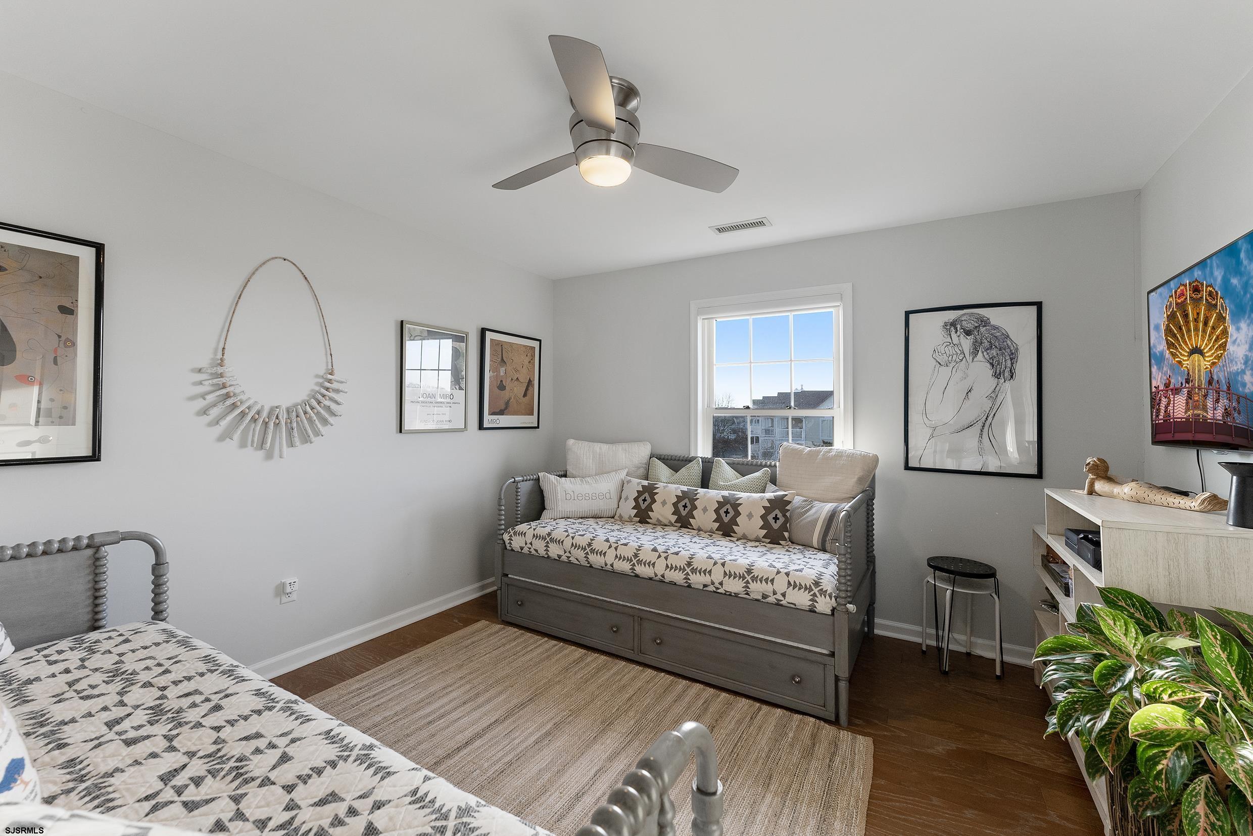 102 Broadway, Unit 2 Somers Point, NJ 08244 - Photo 40 of 98 a bedroom with a bed and a couch