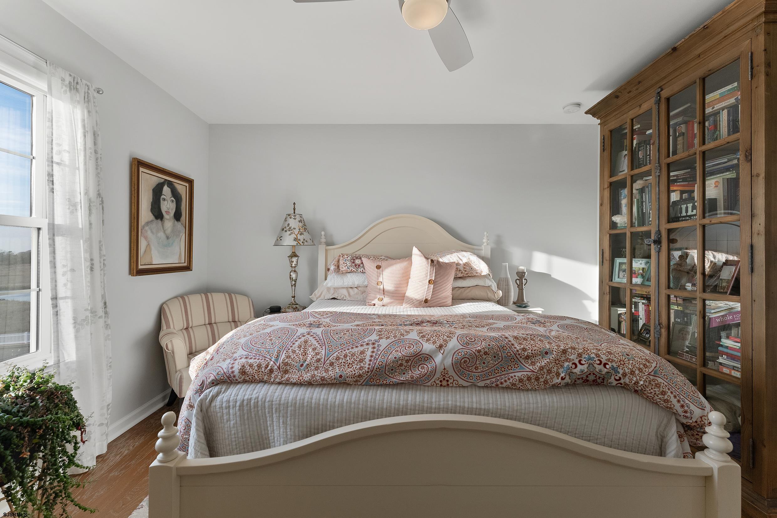 102 Broadway, Unit 2 Somers Point, NJ 08244 - Photo 43 of 98 a bedroom with a bed and a potted plant