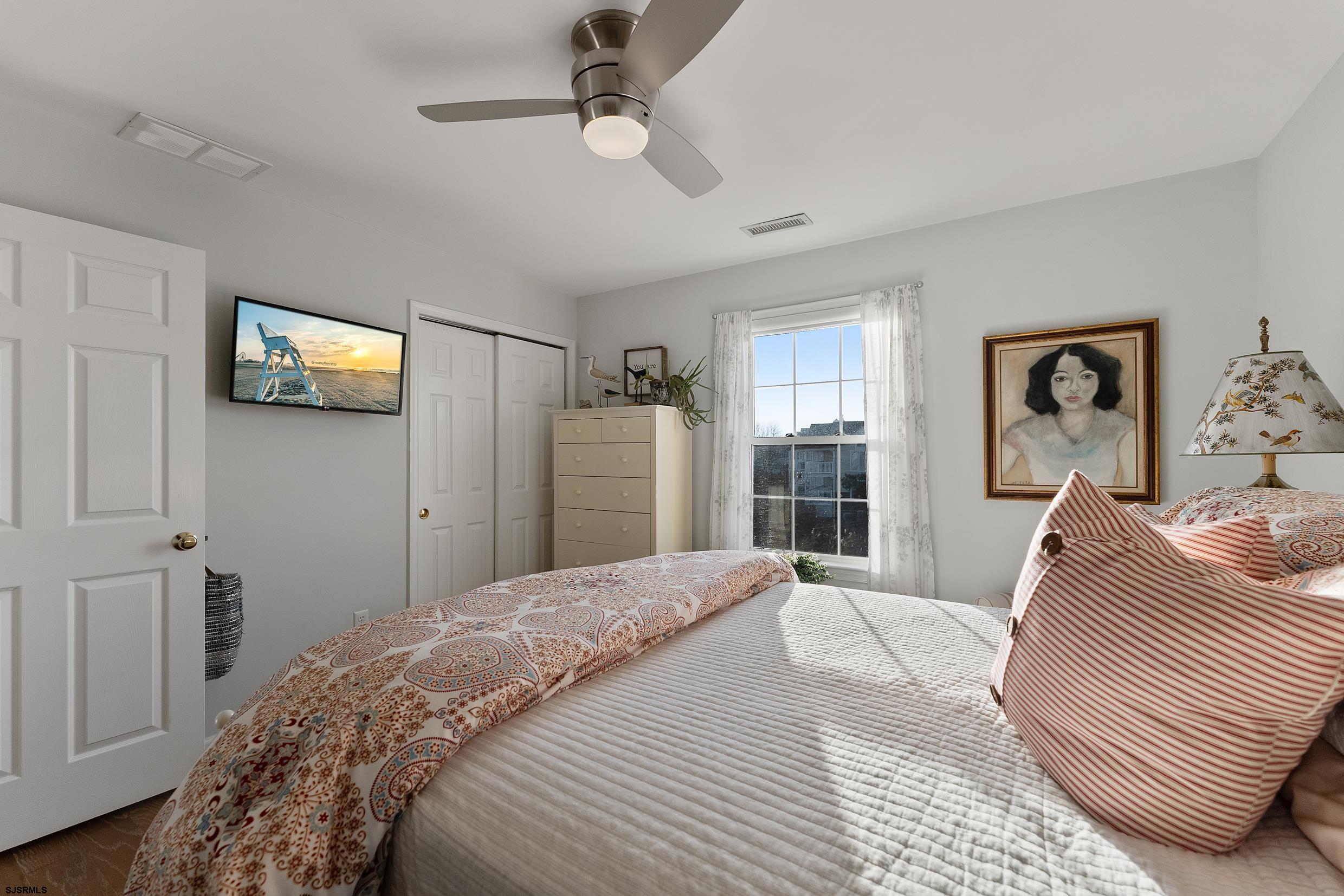 102 Broadway, Unit 2 Somers Point, NJ 08244 - Photo 44 of 98 a bedroom with a bed and a window