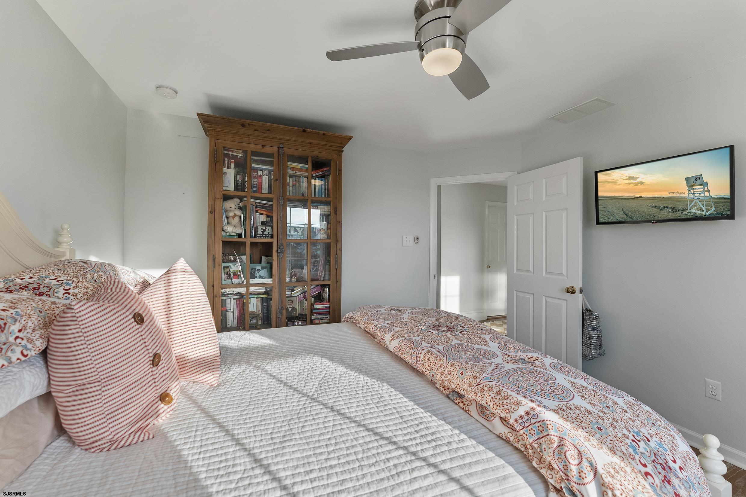 102 Broadway, Unit 2 Somers Point, NJ 08244 - Photo 45 of 98 a bedroom with a large bed and a window