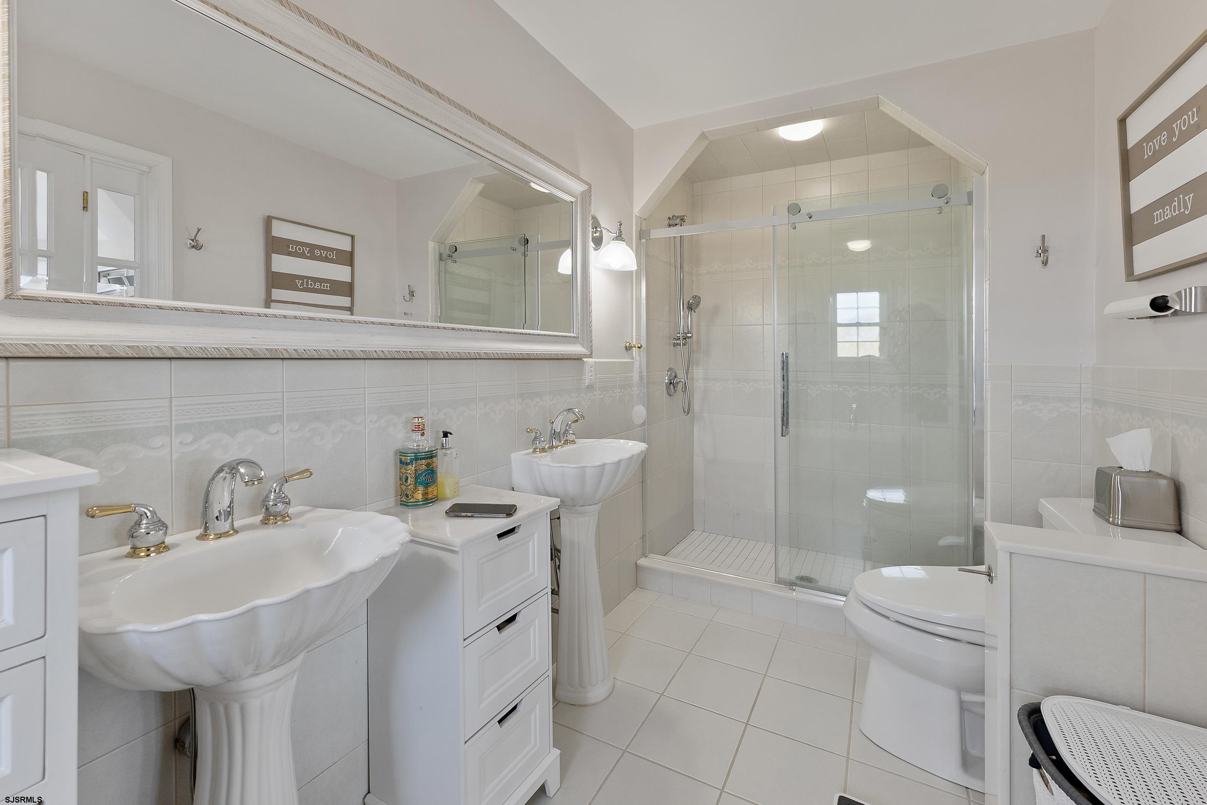 102 Broadway, Unit 2 Somers Point, NJ 08244 - Photo 48 of 98 a bathroom with a sink a toilet and shower