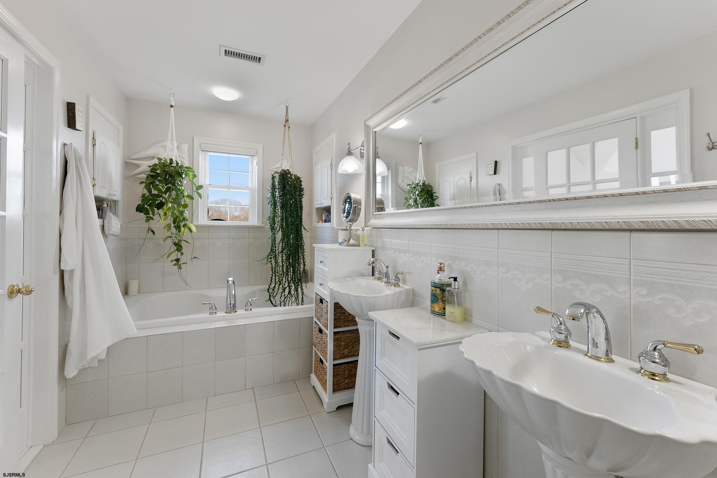102 Broadway, Unit 2 Somers Point, NJ 08244 - Photo 50 of 98 a bathroom with a sink a toilet and shower